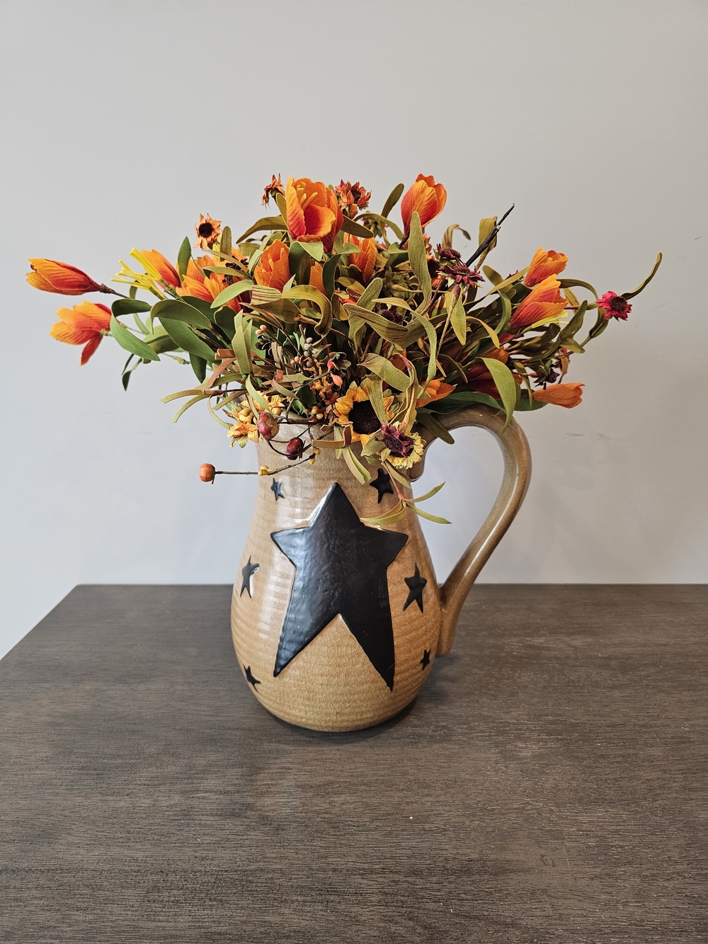 Primitive Star Pitcher Vase with Orange Floral Arrangement